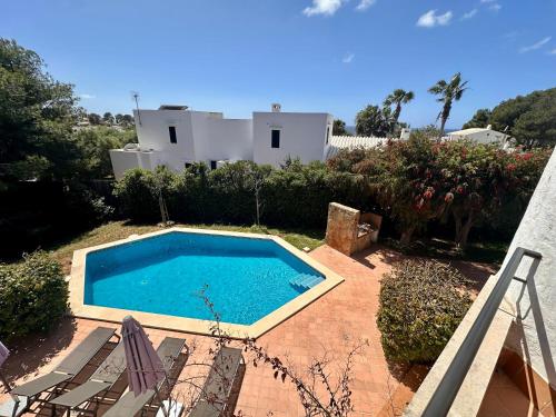 a swimming pool in the yard of a house at Villa ADELE Binibeca sea view in Binibeca