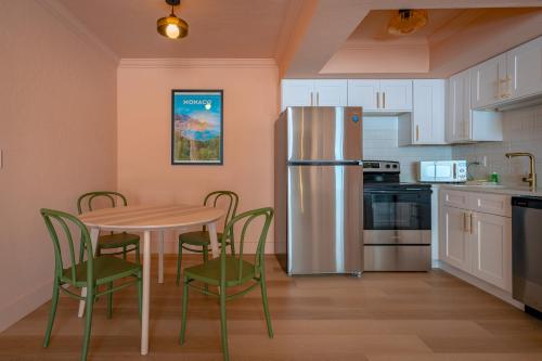 a kitchen with a table and chairs and a refrigerator at Monaco Vacation Rentals in Clearwater Beach