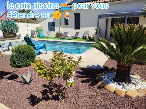 a backyard with a swimming pool and two plants at Chez Brigitte Chambre d hôtes avec cour privative,piscine, in Sorgues