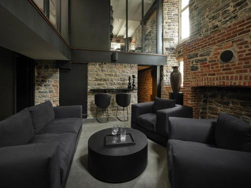 a living room with a couch and a coffee table at Hôtel Maison du Fort in Quebec City