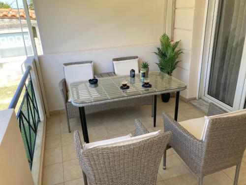 a small table and chairs on a balcony at Unique Apartment in Alexandroupoli