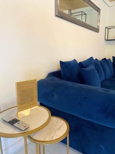a blue couch with a table with a laptop on it at Hunters Hideaway-Hot Tub-Wiltshire-Groups in Warminster