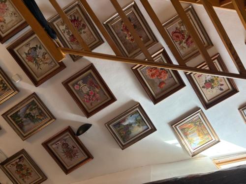 a room with paintings on the wall at la bella de plaza mayor in Madrid