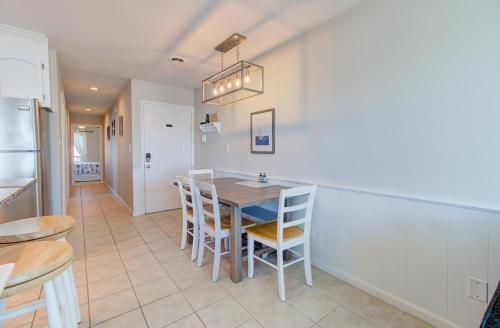 a kitchen and dining room with a table and chairs at Royal Sands I B3: The Sandcastle by Carolina Beach Realty in Carolina Beach