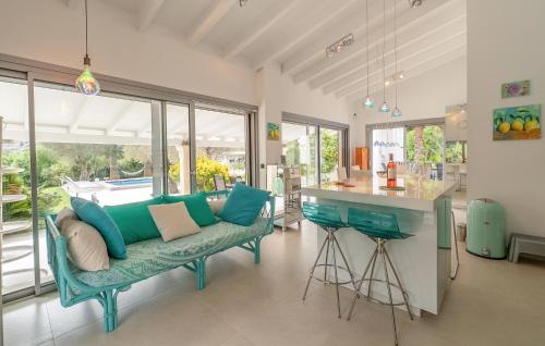 a living room with a green couch and a counter at Ca'n Fanals in Alcudia