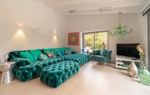 a living room with a green couch and a television at Ca'n Fanals in Alcudia