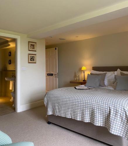 a bedroom with a large bed and a lamp at The Punch Bowl Inn in Kendal