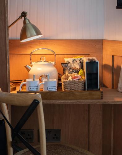 a table with a tea pot and a basket of food at The Old Farmhouse Pub and Rooms in London