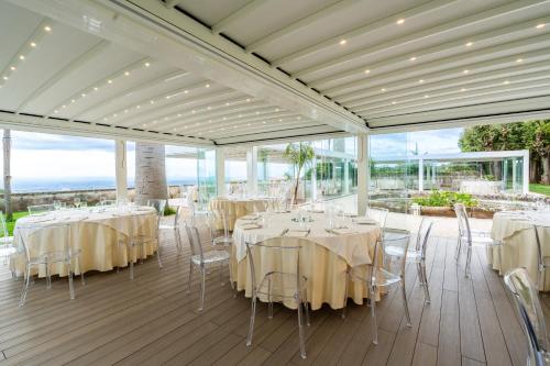 a banquet hall with tables and chairs on a deck at Park Hotel Villa Grazioli in Grottaferrata