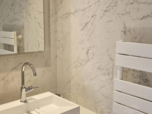 une salle de bain blanche avec un lavabo et un miroir dans l'établissement Villa de maître avec piscine privée pour 14 personnes, climatisation et animaux admis - FR-1-768-62, aux Issambres