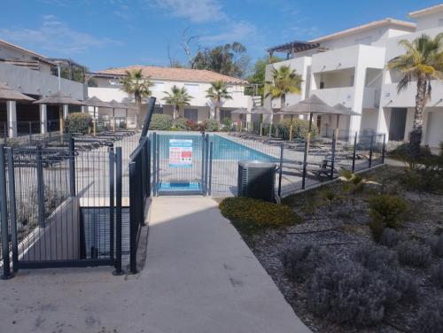 a gate leading to a swimming pool at a building at T2 Waterfront Linguizzetta in Linguizzetta