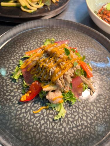 a plate of food with meat and vegetables on it at Agriturismo Zapparè Farm Hotel in Trevignano
