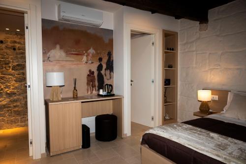 a bedroom with a bed and a painting on the wall at La porta sul Duomo in Barletta