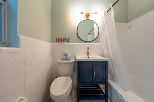 a bathroom with a toilet and a mirror at Monaco Vacation Rentals in Clearwater Beach