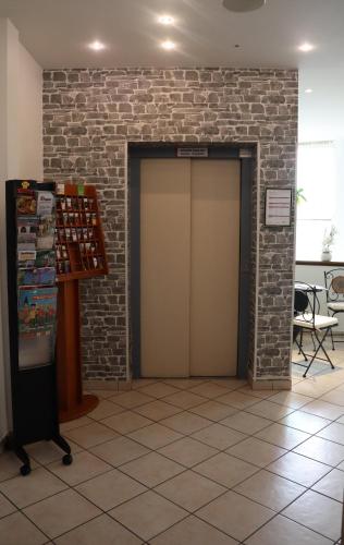 a building with a brick wall and a door at Hotel Haarener Hof in Bad Wünnenberg