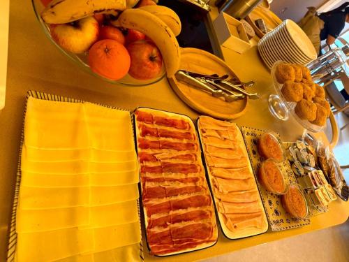 a table with a bunch of bread and fruit on it at Hotel Rural Casa del Oso in El Oso