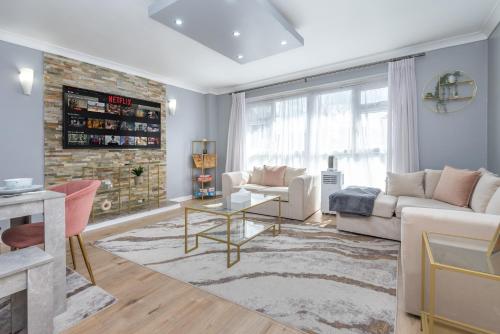 a living room with a couch and a table at Spacious 2BR home in Croydon with parking in Wallington