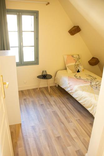 une petite chambre avec un lit et une fenêtre dans l'établissement Duplex Deux Chambres, à Bergerac