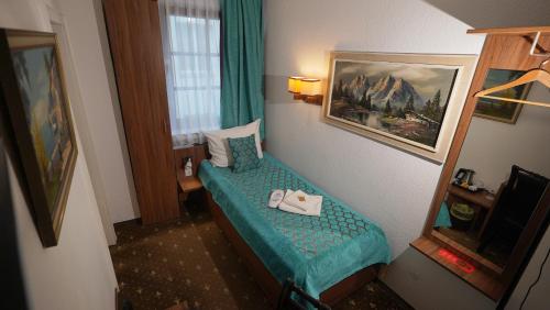 Ένα ή περισσότερα κρεβάτια σε δωμάτιο στο Hotel und Restaurant Löwenbräu Köln