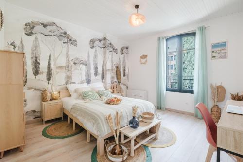 a bedroom with a bed and a table in it at Lavande Dorée in Avignon