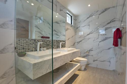 a bathroom with two sinks and a glass shower at Sea view Villa Josefina - 3 bedroom in Nathon Bay