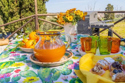 a table with a pitcher of orange juice and cookies at Fiori di Mare in Le Foci