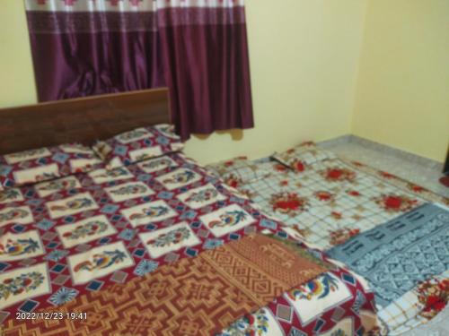 a bed with a bunch of boxes on it at Saurabh Guest House, Akkalkot in Akalkot
