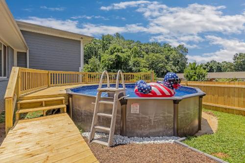 a hot tub with a ladder next to a deck at Mins to Downtown - Huntsville Oasis in Huntsville