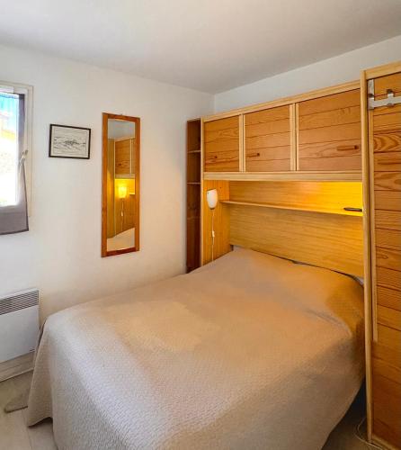 une petite chambre avec un lit et un miroir dans l'établissement Superbe vue Appartement 4 à 6 personnes front de mer 6FLOTB79, au Barcarès