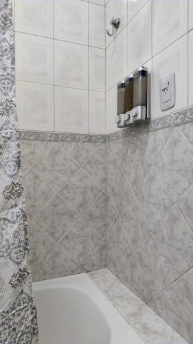 a bathroom with a shower with a toilet and a sink at Esencia de Montaña in El Challao