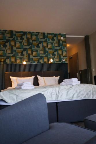 a bedroom with a large bed with white sheets at Gästehaus Dresdner Hof in Zittau