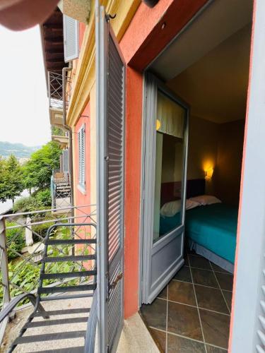 a balcony view of a room with a bed at Appartamento Motta in Orta San Giulio