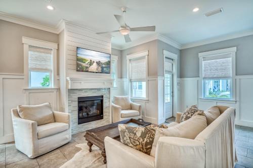 a living room with a couch and a fireplace at Sanity By the Sea by 30A Escapes in Inlet Beach