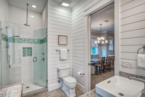 a bathroom with a toilet and a shower and a sink at Sanity By the Sea by 30A Escapes in Inlet Beach