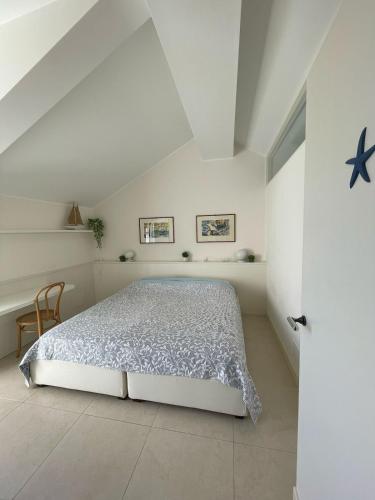 a bedroom with a bed in a white room at Blue horizon retreat-Luxury Penthouse in Rapallo