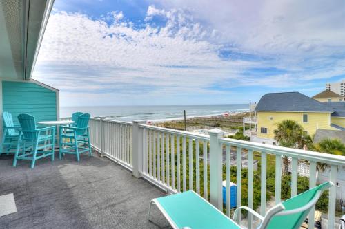 a balcony with chairs and a table and the ocean at Sands V A3 by Carolina Beach Realty in Carolina Beach