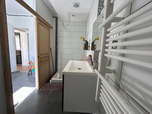 a bathroom with a white sink and a shower at Superbe appart rénové vue sur Meuse Le Chic dans le pré in Bogny Sur Meuse