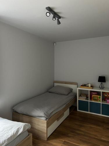 a bedroom with a bed and a ceiling fan at Domek na Morenowym Wzgórzu, nad jeziorem in Mierzyn