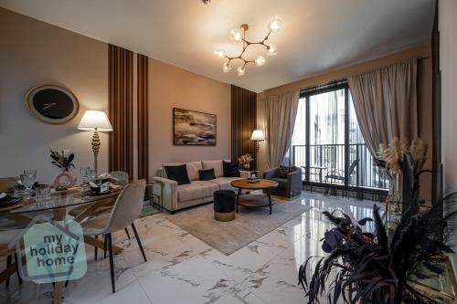 a living room with a couch and a table at Private Beach 1BR-Yacht Club-Work Space-Pool-Gym in Ras al Khaimah