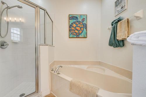 a white bathroom with a tub and a shower at Pool Access Family-Friendly Poinciana Condo! in Poinciana