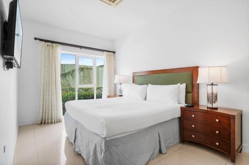 a bedroom with a large bed and a window at Aruba's Life Residences in Noord