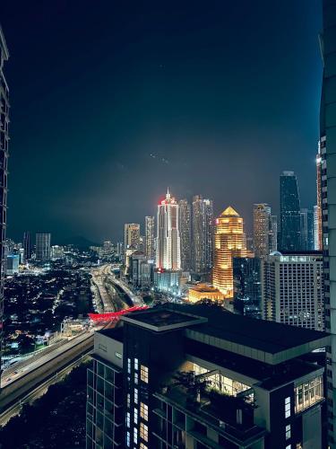 a view of a city skyline at night at Summer Suites KLCC By City Home Style in Kuala Lumpur