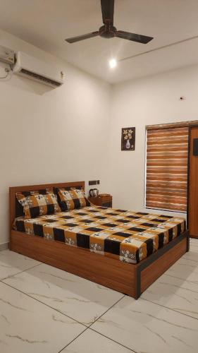 a large bed in a room with a ceiling at Cliff Vista by Saash Hotels in Varkala
