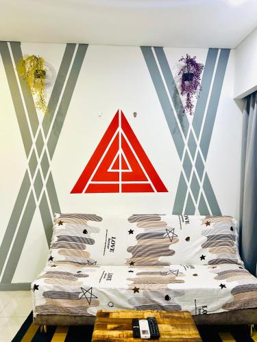 a bed in a room with a painting on the wall at Summer Suites KLCC By City Home Style in Kuala Lumpur