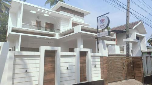 a house with white doors in front of it at Cliff Vista by Saash Hotels in Varkala