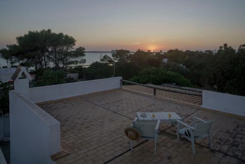 a patio with a table and a view of the sunset at Casa Armonia in Illes Balears