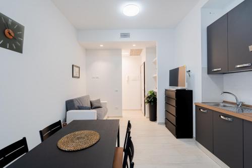 a kitchen and a dining room with a table and chairs at Casa Del Sole in Lanciano