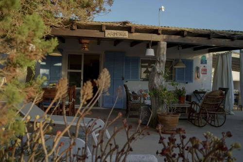 a porch of a house with a table and chairs at Casa Armonia in Illes Balears