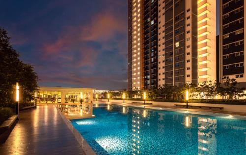 a large swimming pool in a city at night at Alanis Suite Homestay Fully Air-Con Suite Nilai KLIA in Sepang