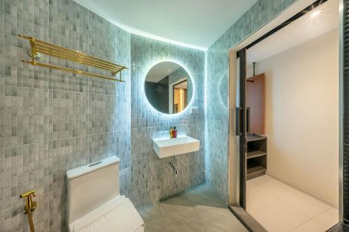 a bathroom with a sink and a mirror at U TOR Yaowarat in Bangkok